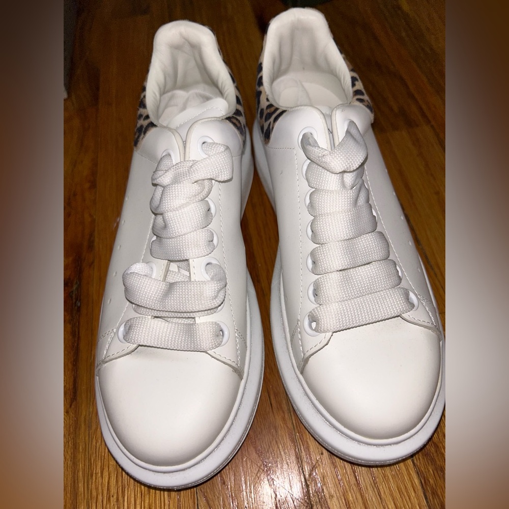 White Alexander McQueen Sneaker with cheetah print on the back.